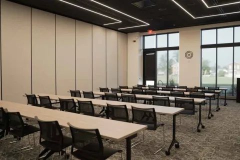Marion Public Library's Community Room A setup, including tables and chairs and overhead technology.