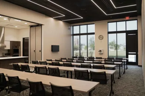 Marion Public Library's Community Room B setup, including tables and chairs and overhead technology.
