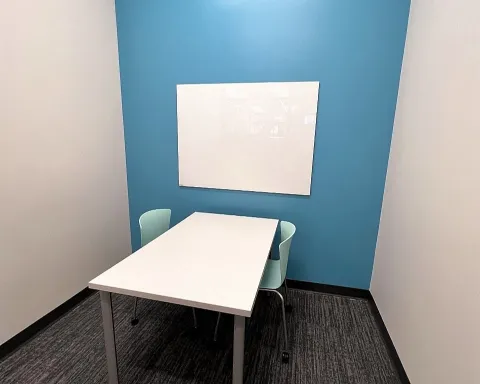 Study room with table, chairs, and whiteboard