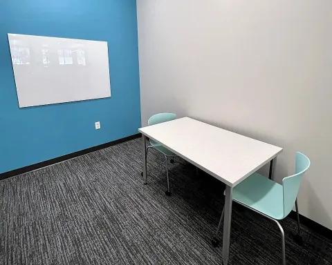 Study room with table, chairs, and whiteboard
