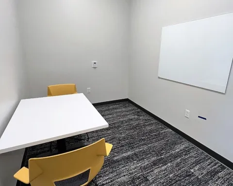 Study room with table, chairs, and whiteboard