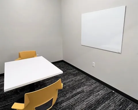 Study room with table, chairs, and whiteboard