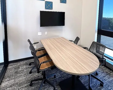 Study room with table, chairs, and TV screen