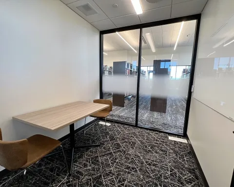 Study room with table, chairs, and whiteboard