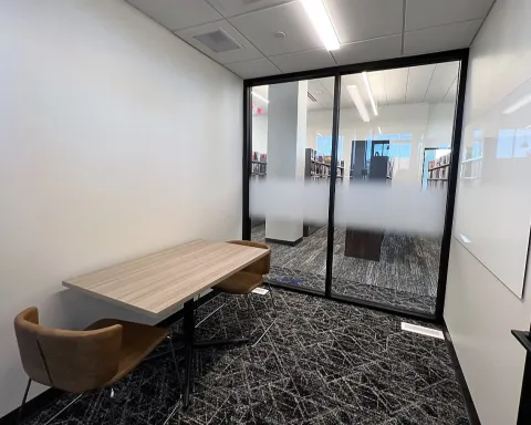 Study room with table, chairs, and whiteboard