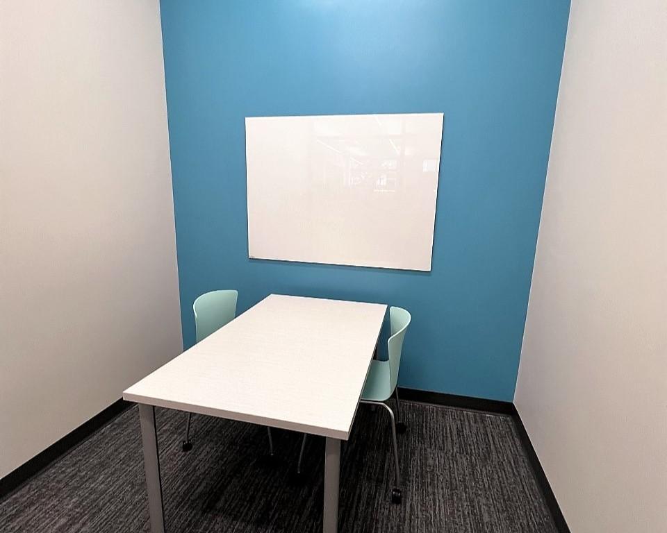 Study room with table, chairs, and whiteboard