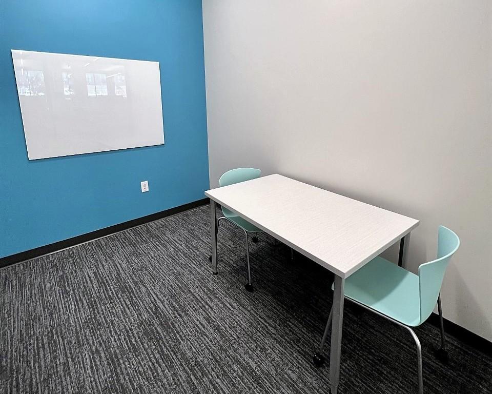 Study room with table, chairs, and whiteboard