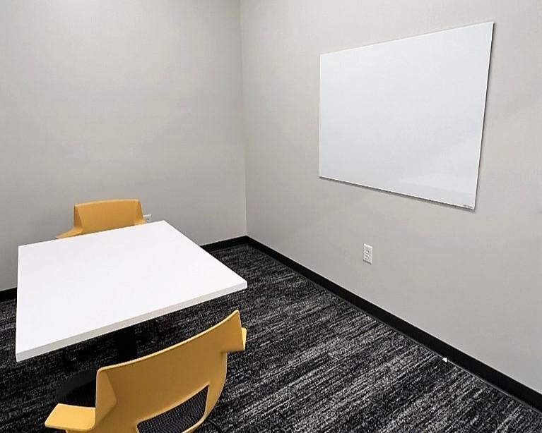 Study room with table, chairs, and whiteboard