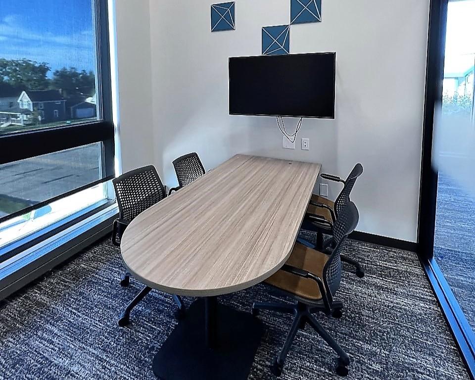 Study room with table, chairs, and TV screen