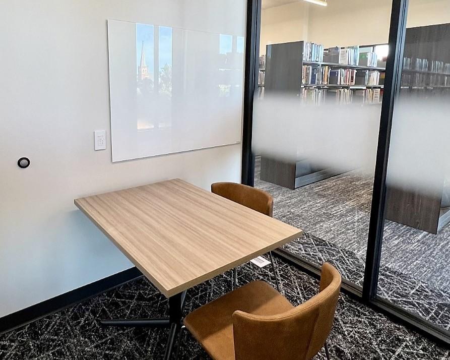 Study room with table, chairs, and whiteboard