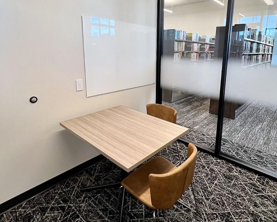 Study room with table, chairs, and whiteboard