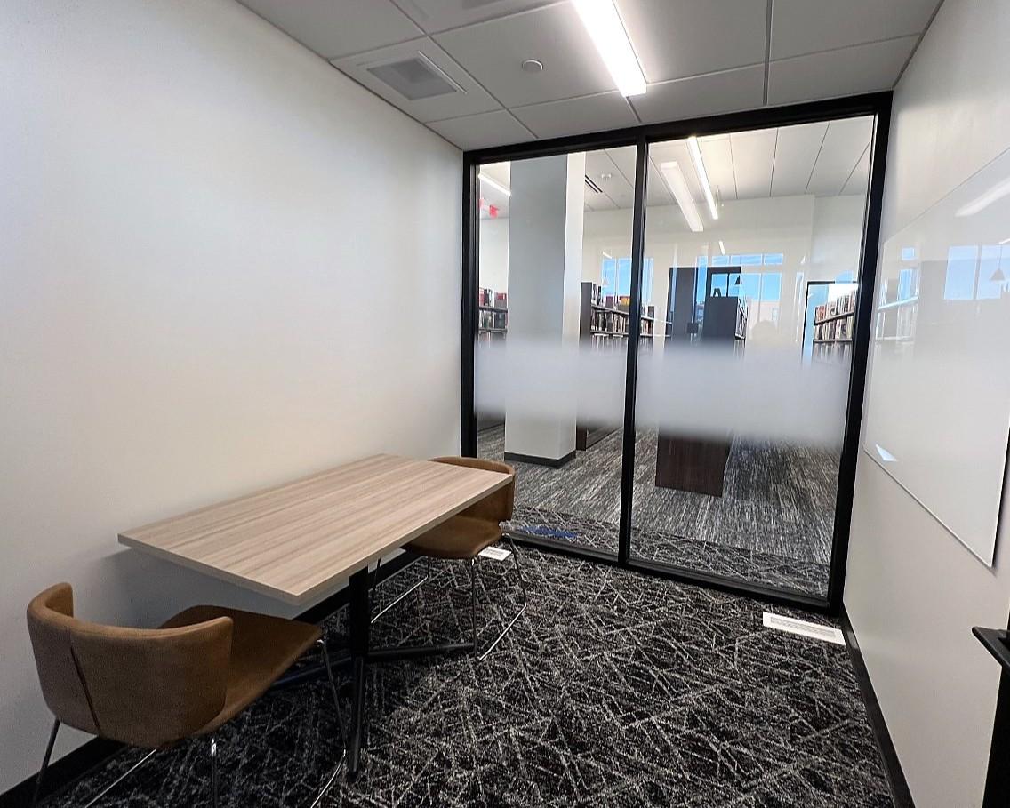Study room with table, chairs, and whiteboard